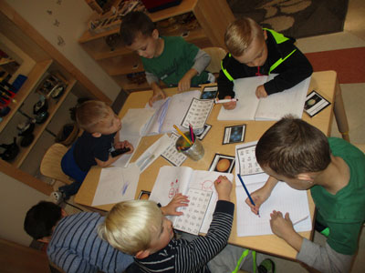 Preschool students practicing letters