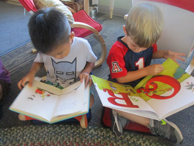 Two preschool students reading